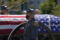 A caisson approaches the Holmes Convocational Center for the funeral services of Watauga County Sheriff's Deputies Sgt. Chris Ward and K-9 Deputy Logan Fox in Boone, N.C., Thursday, May 6, 2021. The two deputies were killed in the line of duty. (AP Photo/Gerry Broome)