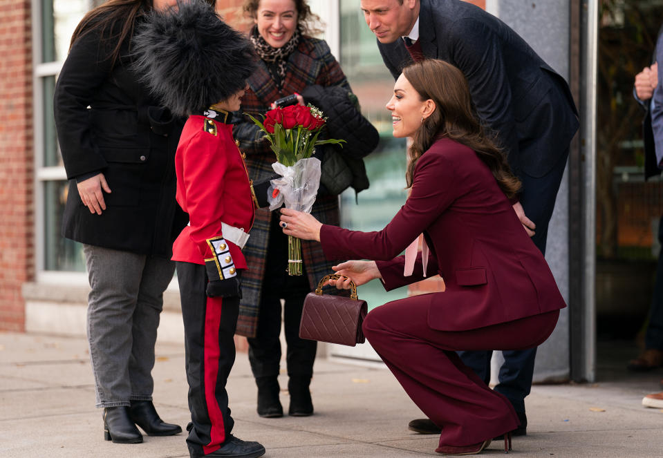 <p>Prince William and Kate Middleton are greeted by an 8-year-old named Henry, dressed as a mini royal guard, while visiting Boston on Dec. 1. </p>