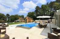 <p>Outside, there is a large heated pool with a relaxing water feature.</p>