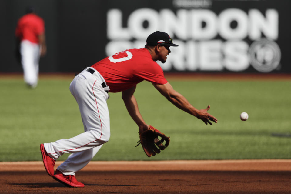 Boston Red Sox third baseman Marco Hernandez fields a ball during batting practice in London, Friday, June 28, 2019. Major League Baseball will make its European debut with the New York Yankees versus Boston Red Sox game at London Stadium this weekend. (AP Photo/Frank Augstein)