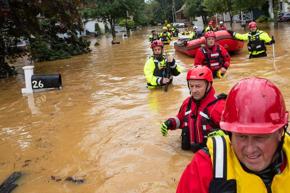 A volunteer fire company assists with evacuation efforts following a flash flood in Helmetta, New Jersey, in August 2021. <a href="https://www.gettyimages.com/detail/news-photo/members-of-the-new-market-volunteer-fire-company-perform-a-news-photo/1234816728" rel="nofollow noopener" target="_blank" data-ylk="slk:Tom Brenner / AFP via Getty Images;elm:context_link;itc:0;sec:content-canvas" class="link ">Tom Brenner / AFP via Getty Images</a>