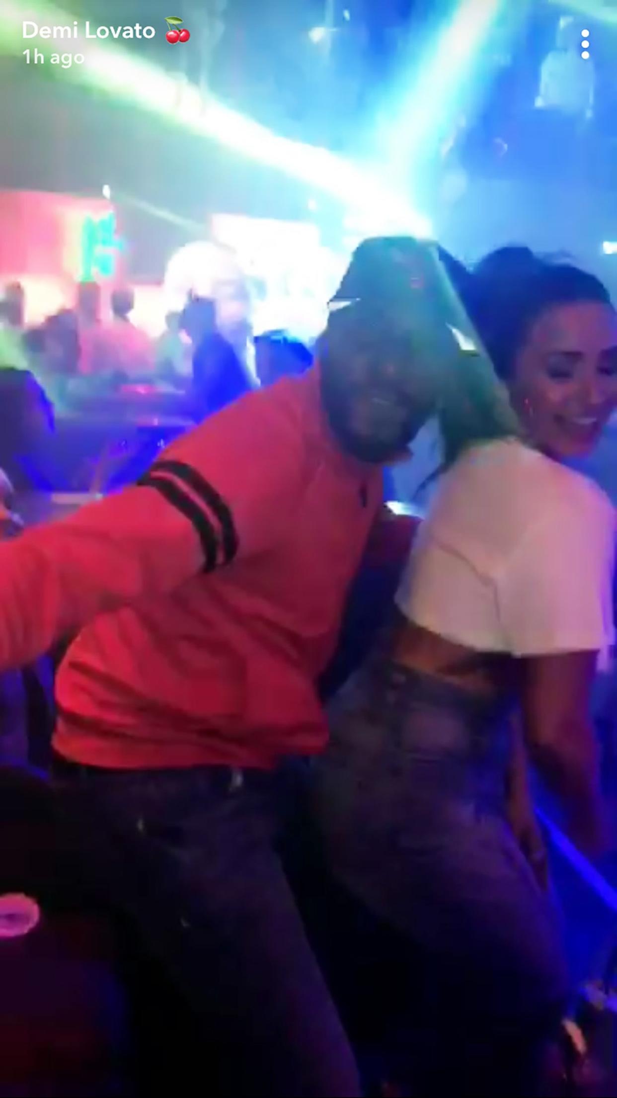 Demi Lovato dances with a friend