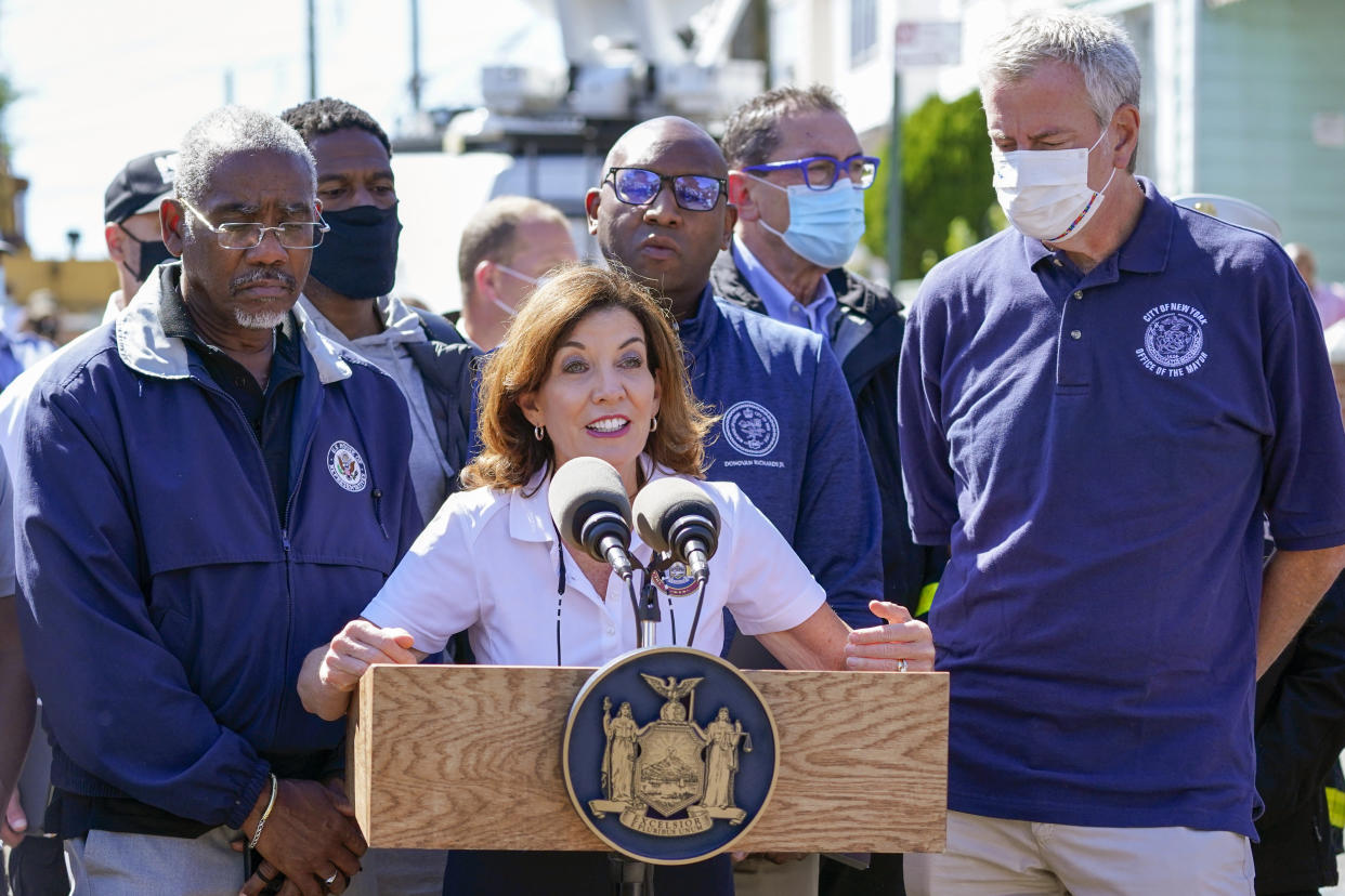 New York Gov. Kathy Hochul is joined by New York City Mayor Bill de Blasio, right, and other officials during a news conference In Queens. (Mary Altaffer/AP)