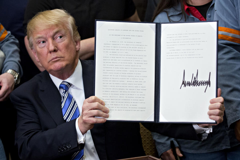 US President Donald Trump signing into law new tariffs on foreign steel and aluminium in March (Getty)