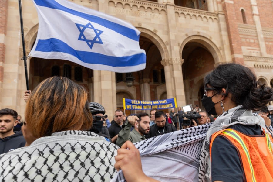 LOS ANGELES, CALIFORNIA – APRIL 25: A group of Israeli, holding flags, face against Pro-Palestinian students as they gather to protest against Israeli attacks on Gaza at University of California (UCLA) in Los Angeles, California, United States on April 25, 2024. (Photo by Grace Hie Yoon/Anadolu via Getty Images)