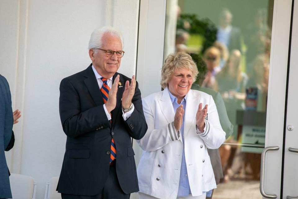 Ocala Mayor Kent Guinn and WEC owner Mary Roberts clap as the UF Veterinary Hospital at WEC opened with a ribbon cutting Wednesday in Ocala.