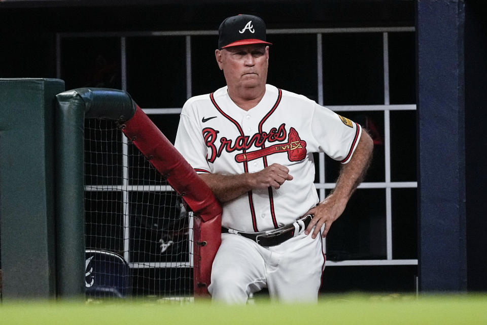Atlanta Braves manager Brian Snitker watches from the dugout during the team's baseball game against the New York Yankees, Wednesday, Aug. 16, 2023, in Atlanta. (AP Photo/John Bazemore)