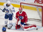 Laval Rocket goaltender Carey Price, right, makes a save as Toronto Marlies' Stefan Noesen looks for the rebound during first-period American Hockey League action in Montreal, Monday, May 17, 2021. Price and Brendan Gallagher are on a one-game conditioning loan to the Rocket before their playoff series against the Toronto Maple Leafs. (Ryan Remiorz/The Canadian Press via AP)