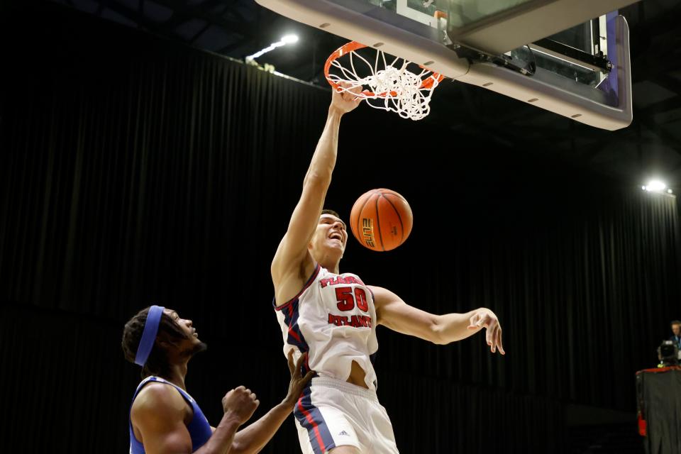 Florida Atlantic center Vladislav Goldin (50) dunks the ball over Middle Tennessee forward Deandre Dishman during the first half of a NCAA college basketball game in the semifinals of the Conference USA Tournament in Frisco, Texas, Friday, March 10, 2023. (AP Photo/Michael Ainsworth)