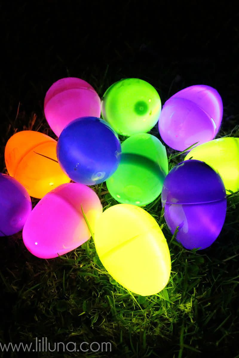colorful glowing plastic eggs in grass for a nighttime easter egg hunt for older kids or adults