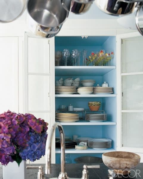 <p>Hand-painted glassware and collections of china become the focal point in the small kitchen of a Connecticut house designed by Lou Marotta. The cupboard's <a rel="nofollow noopener" href="https://www.elledecor.com/design-decorate/color/g3275/blue-paint-colors/" target="_blank" data-ylk="slk:light blue;elm:context_link;itc:0;sec:content-canvas" class="link ">light blue</a> backing draws the eye directly to the statement items.</p>