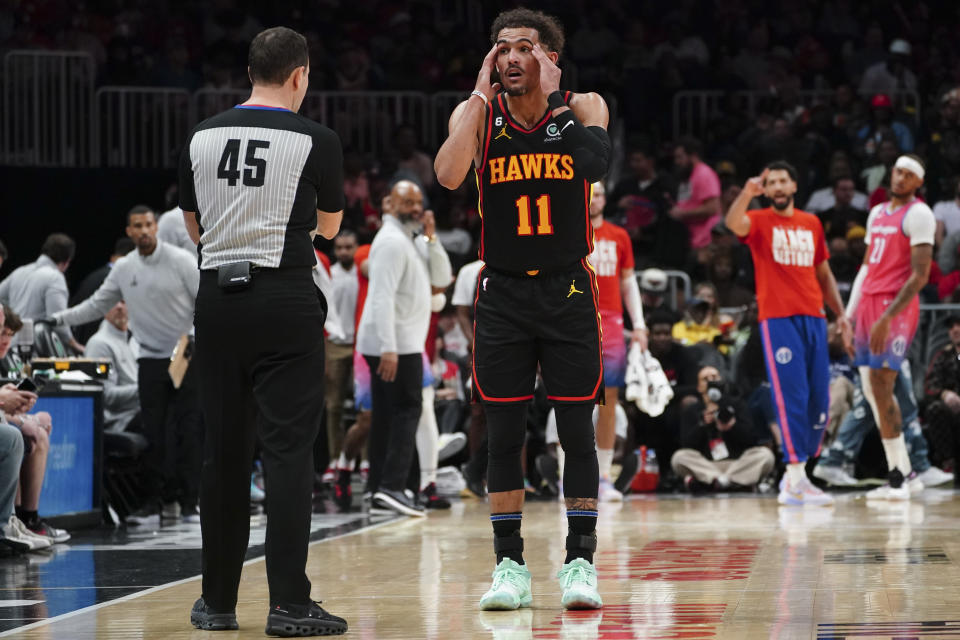 Atlanta Hawks guard Trae Young (11) reacts after being called for a foul during the first half of an NBA basketball game against the Washington Wizards Tuesday, Feb. 28, 2023, in Atlanta. (AP Photo/John Bazemore)