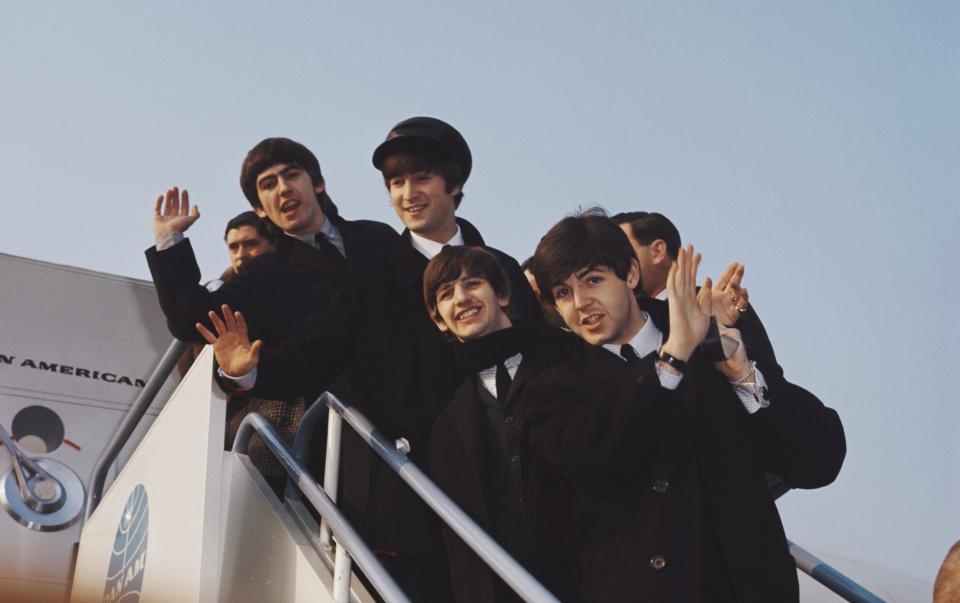 George Harrison, John Lennon, Ringo Starr and Paul McCartney of the English pop group The Beatles, pictured together on the steps of a Pan American 707 jetliner after arriving at John F Kennedy Airport