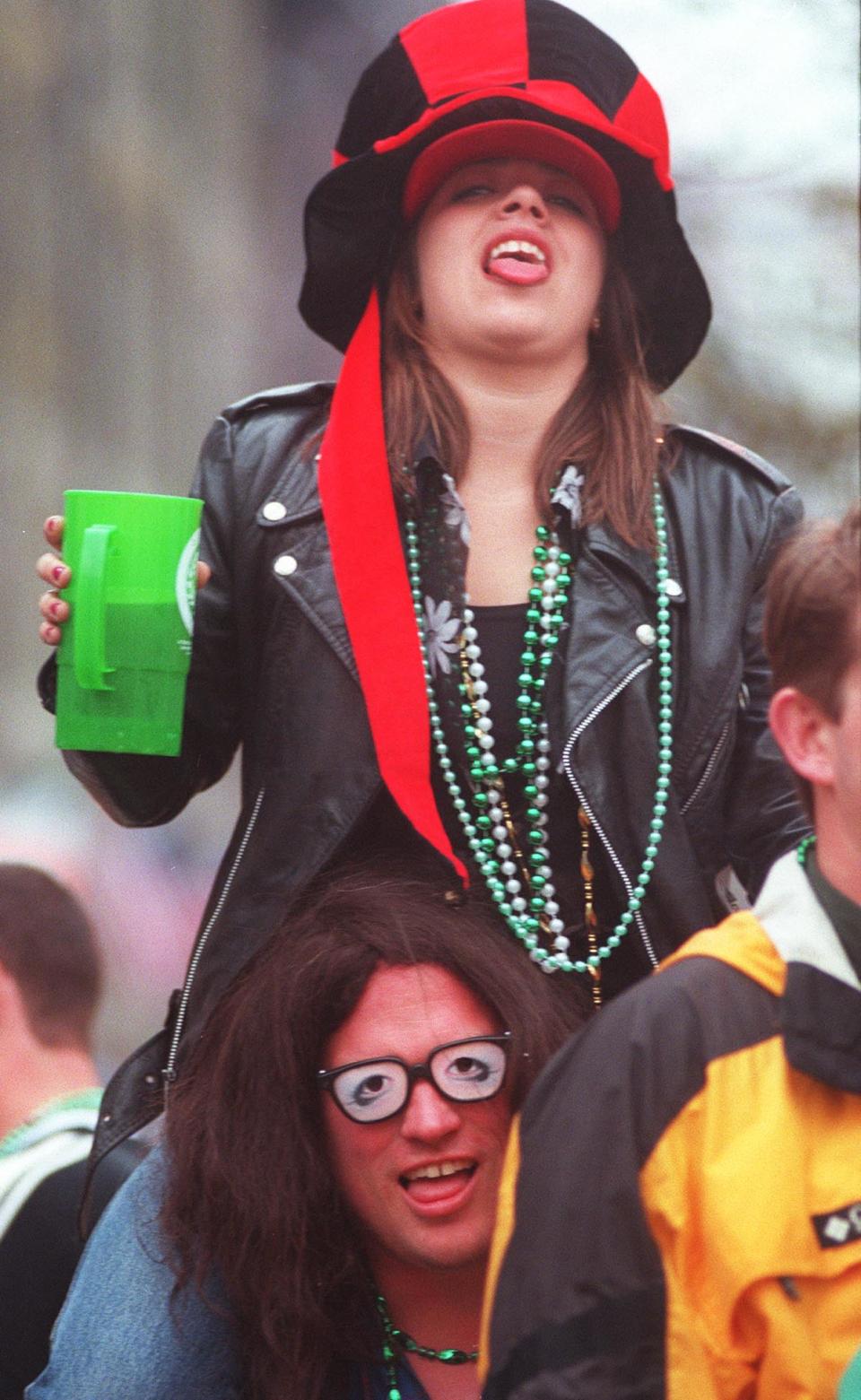 Shannon Huff sits on Tom Rudisill's shoulders during the 2001 St. Patrick's Day Celebration on River Street.