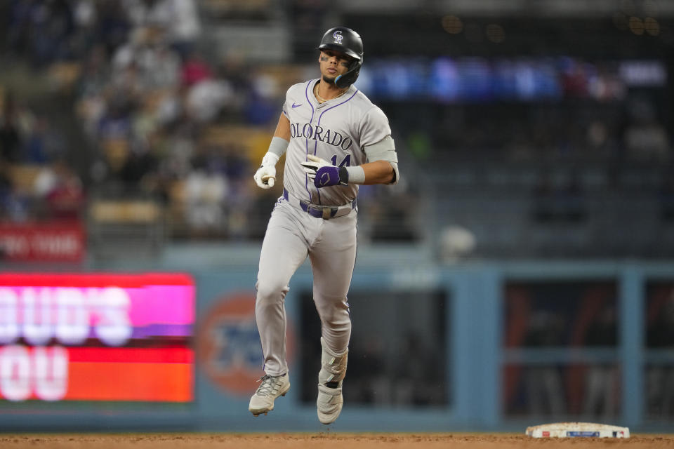 Colorado Rockies' Ezequiel Tovar (14) runs the bases after hitting a home run during the fourth inning of a baseball game against the Los Angeles Dodgers in Los Angeles, Friday, May 31, 2024. (AP Photo/Ashley Landis)
