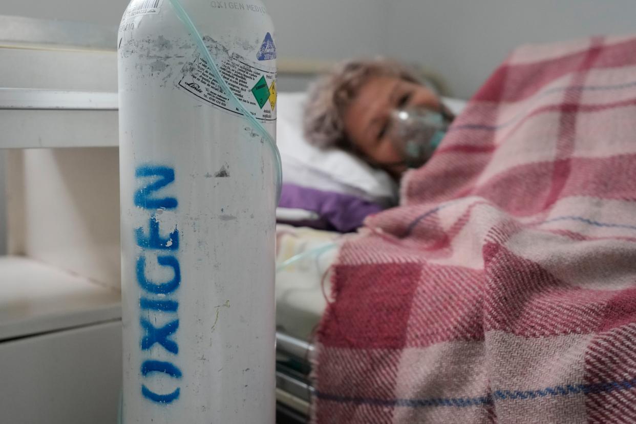 A patient breathes through an oxygen mask at the COVID-19 unit of the Marius Nasta National Pneumology Institute in Bucharest, Romania, Thursday, Sept. 23. 