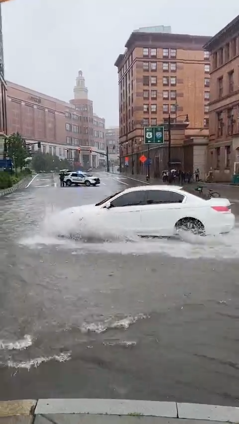 Flooding around Kennedy Plaza in Providence forces drivers to detour around massive puddles amid heavy rainfall on July 10.