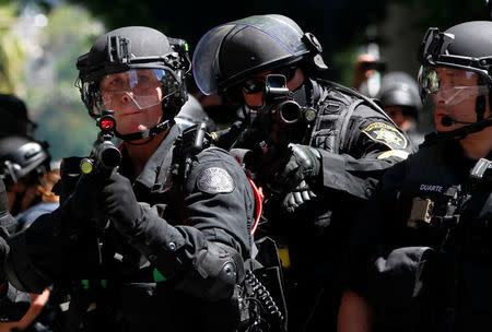 Police fire projectiles at counter-protesters during a rally by the Patriot Prayer group in Portland, Oregon, U.S. August 4, 2018. REUTERS/Bob Strong