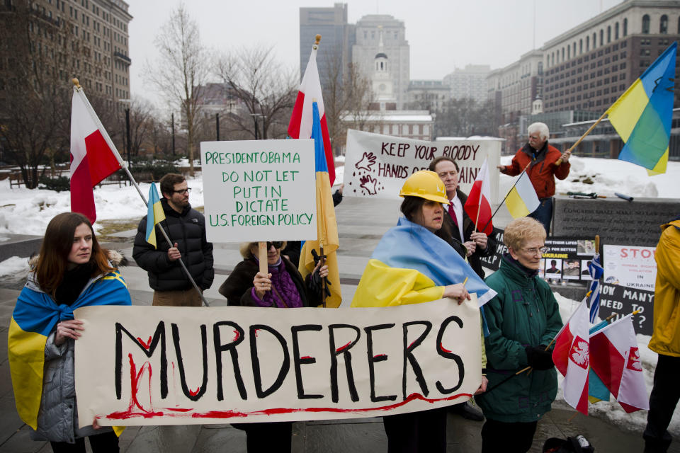 Members of the Ukrainian American and Polish American communities demonstrate in support Ukrainian anti-government protesters outside Independence Hall, Wednesday, Feb. 19, 2014, in Philadelphia. The violence on Tuesday was the worst in nearly three months of anti-government protests that have paralyzed Ukraine's capital, Kiev, in a struggle over the identity of a nation divided in loyalties between Russia and the West, and the worst in the country's post-Soviet history. (AP Photo/Matt Rourke)