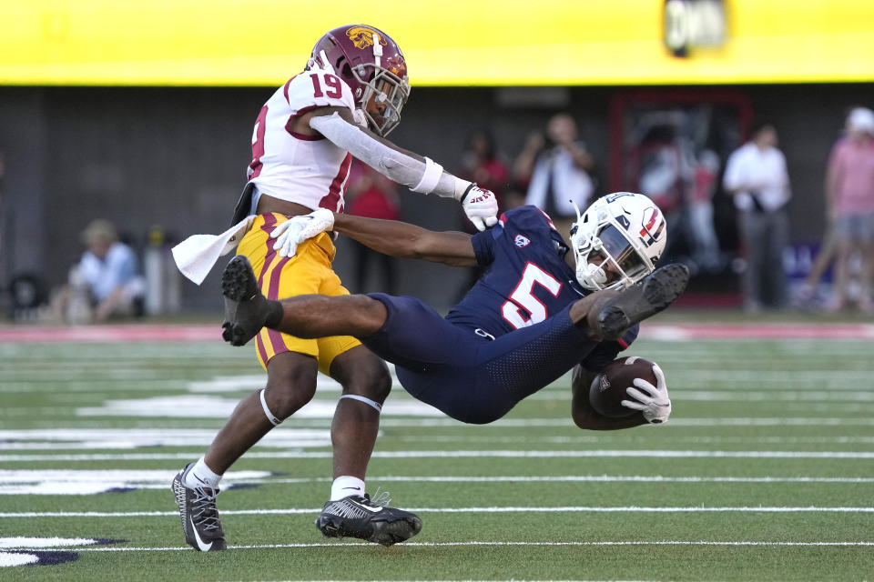 Southern California defensive back Jaylin Smith (19) tackles Arizona wide receiver Dorian Singer for a loss in the first half during an NCAA college football game, Saturday, Oct. 29, 2022, in Tucson, Ariz. (AP Photo/Rick Scuteri)