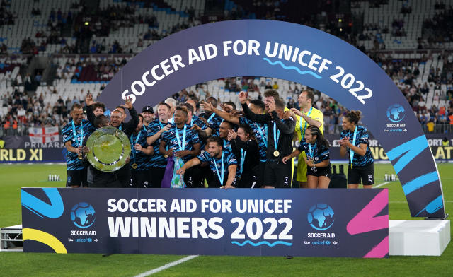 Rest of the World XI players celebrate with the trophy after Soccer Aid 2022