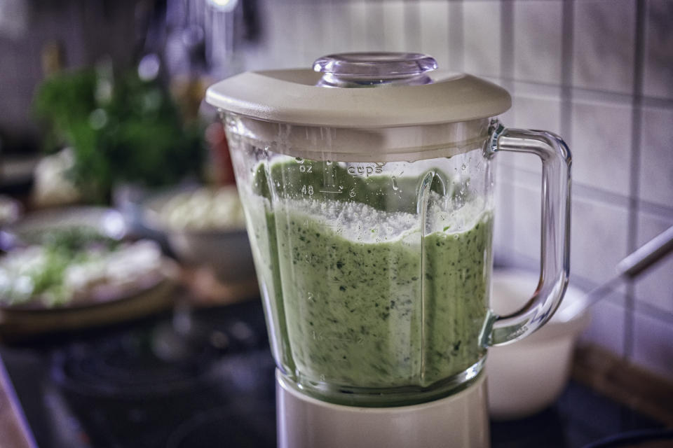 Preparing Green Vegetable Soup with Green Peas, Spinach and Apple Croutons in a blender
