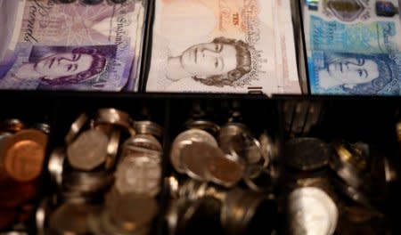 Pound notes and coins are seen inside a cash register in a bar in Manchester, Britain September 6, 2017. REUTERS/Phil Noble