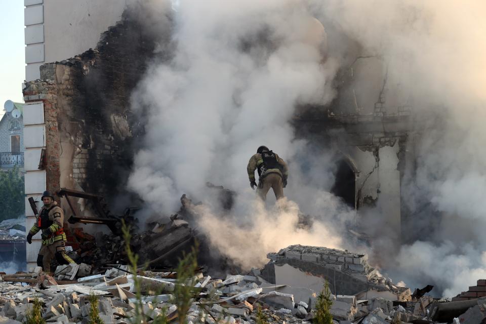 Rescuers work at a house in Kharkiv on May 10, 2024 after a Russian missile attack.