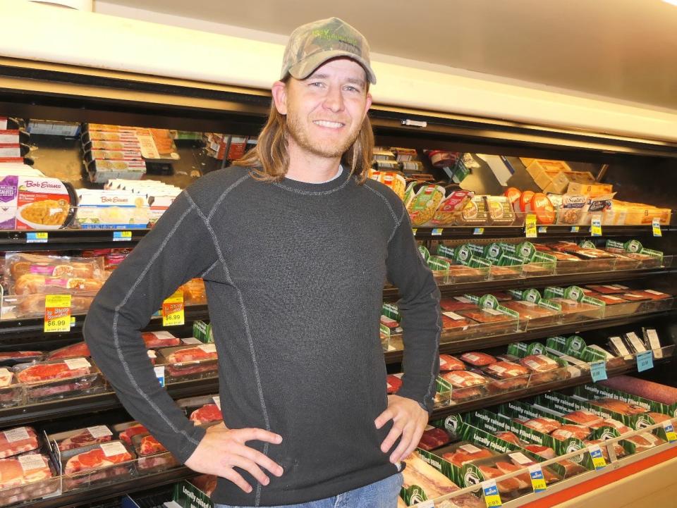 Kevin Morgan of Agridime in front of the meat counter at Barnes Heartland Foods in Herington, Kansas.