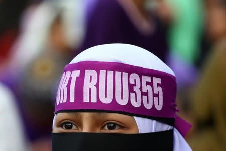 A supporter attends a rally to support the adoption of a strict Islamic penal code at Padang Merbok in Kuala Lumpur, Malaysia, February 18, 2017. REUTERS/Athit Perawongmetha
