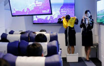 Staff dressed as flight attendants, perform a safety demonstration at the "First Airlines", virtual first-class airline experience facility in Tokyo, Japan February 14, 2018. Picture taken February 14, 2018. REUTERS/Toru Hanai