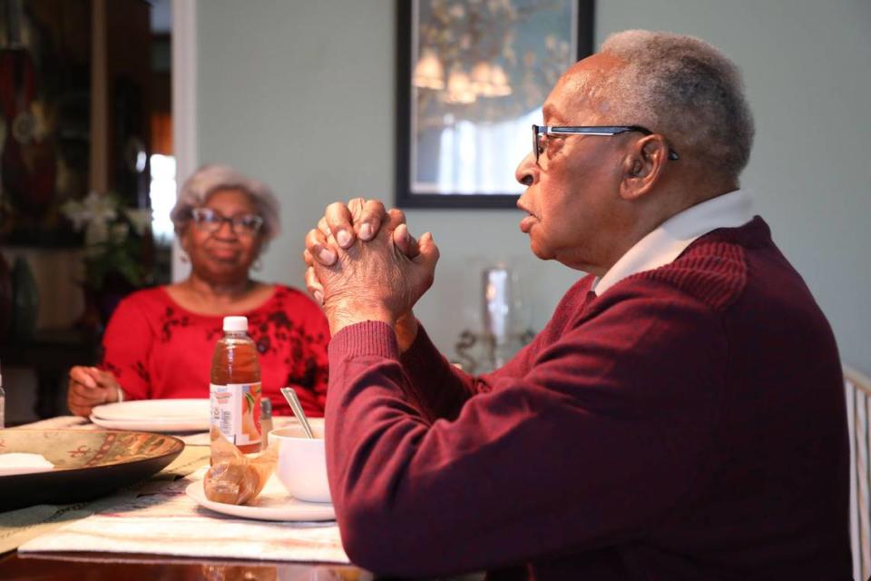 John Crawford remembers back in 1982 when a young man asked him for $300 dollars so that he can finish his senior year in college, reflecting in his Charlotte home on Friday, April 5, 2024. From that moment on, Crawford’s mission was to find money to help poor youth living in public housing who would otherwise not be able to shoulder the hefty cost of attending college. Gayle B. Crawford, his wife is seen in the back.