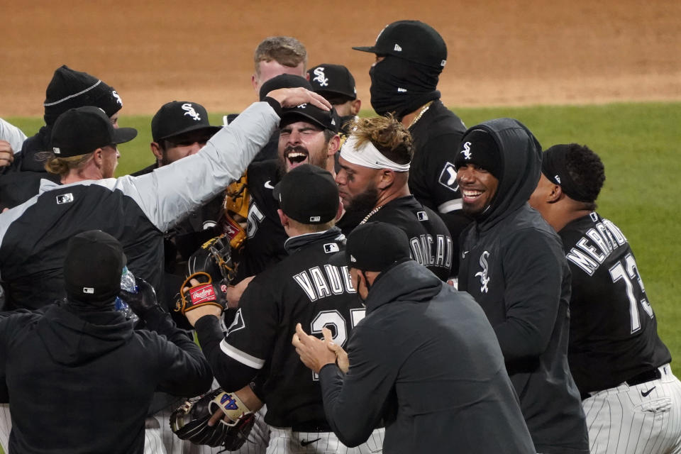 Chicago White Sox starting pitcher Carlos Rodon, center, celebrates his no hitter against the Cleveland Indians with his teammates in a baseball game, Wednesday, April, 14, 2021, in Chicago. (AP Photo/David Banks)