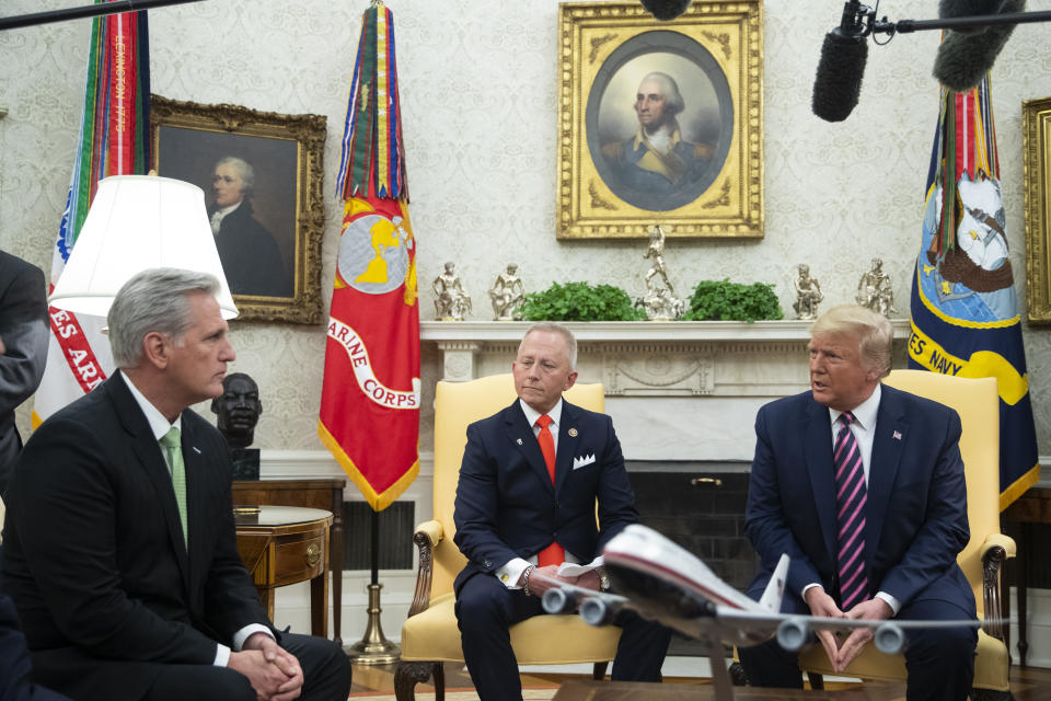 House Minority Leader Kevin McCarthy of Calif., left, and Rep. Jeff Van Drew, D-N.J., who is planning to switch his party affiliation, listen as President Donald Trump speaks during a meeting in the Oval Office of the White House, Thursday, Dec. 19, 2019, in Washington. (AP Photo/ Evan Vucci)