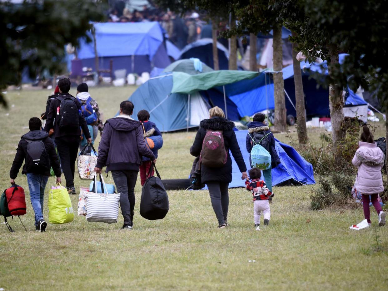 People and children leave after the eviction, by French gendarmes, of the Grande Synthe refugee camp, Dunkirk, on 17 September, 2019: Francois Lo Presti/AFP/Getty Images