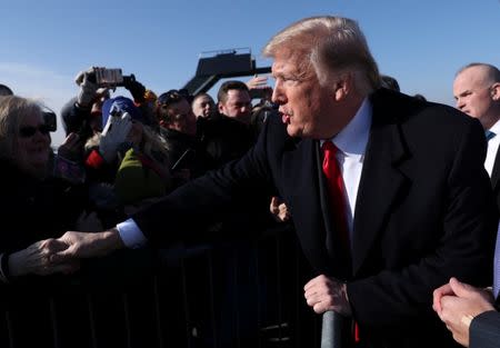 U.S. President Donald Trump is greeted by supporters waiting for him on the airport tarmac as he arrives in Kansas City, Missouri, U.S., December 7, 2018. REUTERS/Jonathan Ernst