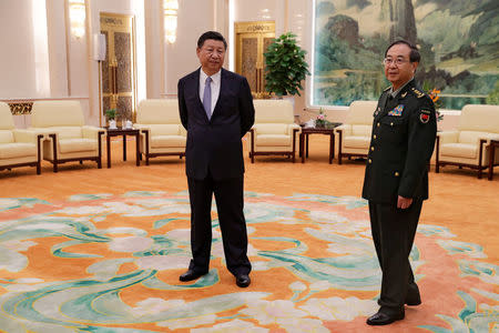 Chinese President Xi Jinping and Gen. Fang Fenghui, chief of the general staff of the Chinese People's Liberation Army, wait to meet with U.S. Chairman of the Joint Chiefs of Staff Gen. Joseph Dunford at the Great Hall of the People in Beijing, China August 17, 2017. REUTERS/Andy Wong/Pool