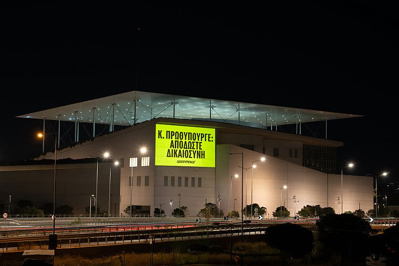 Greenpeace Greece activists project a message reading: Κ. ΠΡΩΘΥΠΟΥΡΓΕ (World Leaders: We Are Watching You) onto the SNFCC conference centre.