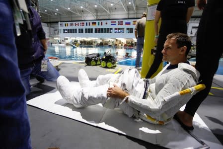 NASA Commercial Crew Astronaut Josh Cassada is helped to get into his space suit at NASA's Neutral Buoyancy Laboratory (NBL) training facility near the Johnson Space Center in Houston