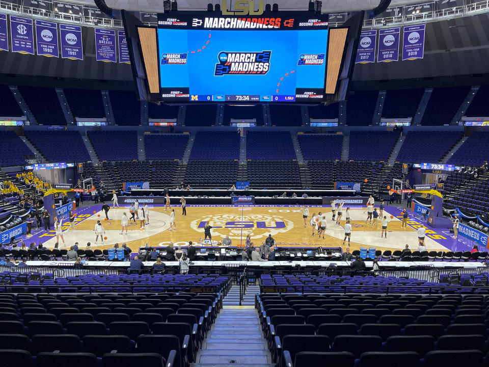 FILE - LSU players, left, and Michigan players warm up in the Pete Maravich Assembly Center for a second-round college basketball game in the women's NCAA Tournament in Baton Rouge, La., Sunday, March 19, 2023. Those who played with, followed or knew the late Maravich are conflicted about the seemingly inevitable moment — likely this Sunday — when he could be supplanted by Iowa women's basketball sensation Caitlin Clark atop the NCAA's all-time scoring list.(AP Photo/Matthew Hinton, File)