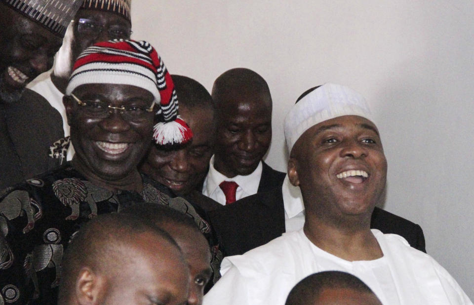 Nigerian Senate president Bukola Saraki (R) and his deputy Ike Ekweremadu (L) leave the courtroom after being charged with falsifying parliamentary rules to get elected in Abuja, in a June 27, 2016 file photo. / Credit: PHILIP OJISUA/AFP via Getty