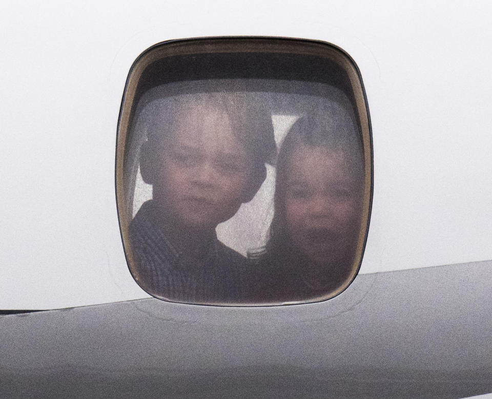 <p>George and Charlotte peered out of the plane as they landed in Warsaw, Poland, on tour with their parents. (Arthur Edwards)</p> 