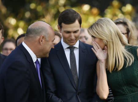 White House senior adviser Ivanka Trump talks with husband and fellow senior adviser Jared Kushner (C), and White House Chief Economic Adviser Gary Cohn prior to a moment of silence in remembrance of those lost in the September 11 attacks on the United States, at the White House in Washington, U.S., September 11, 2017. REUTERS/Kevin Lamarque