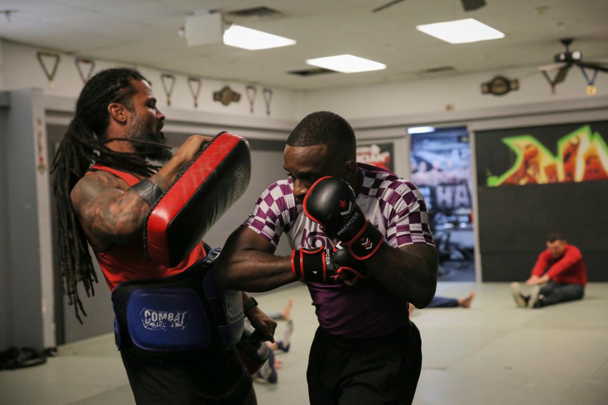 Savannah native and resident Brandon Moran, right, practices his striking with trainer Muhsin Corbbrey at Champions Training Center on Thursday, July 21, 2022.