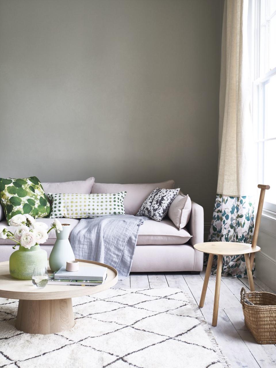 living room with a pale pink sofa and light coloured rug on the floor in frontfrom content by terence conran