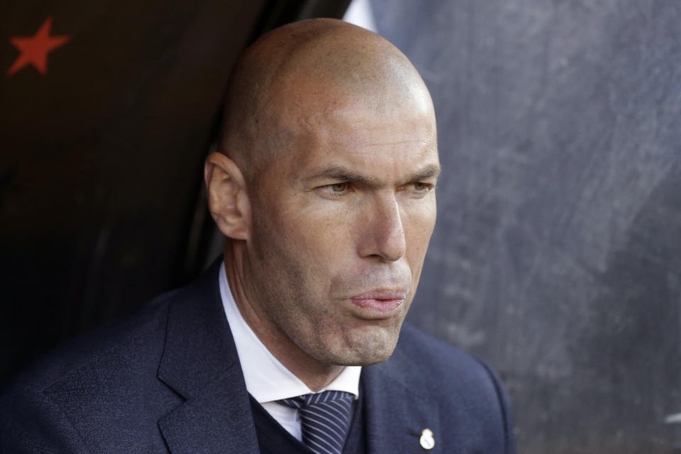 Real Madrid's coach Zinedine Zidane looks out from the bench before the start of a Spanish La Liga soccer match between Rayo Vallecano and Real Madrid at the Vallecas stadium in Madrid, Spain, Sunday, April 28, 2019. (AP Photo/Paul White)