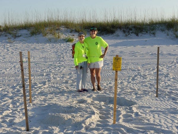 Escambia County Sea Turtle Patrol volunteers mark the first sea turtle nest of 2022 in the early morning hours of May 11.