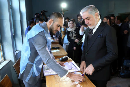 Afghanistan's Chief Executive Abdullah Abdullah arrives to cast his vote during parliamentary election at a polling station in Kabul, Afghanistan, October 20, 2018. Chief Executive Office/Handout via REUTERS