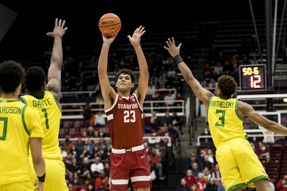 Stanford forward Brandon Angel (23) is defended by Oregon center N'Faly Dante (1) and guard Keeshawn Barthelemy (3) during the first half of an NCAA college basketball game in Stanford, Calif., Saturday, Jan. 21, 2023. (AP Photo/John Hefti)