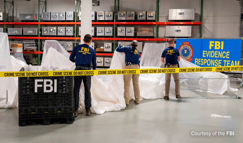 FILE PHOTO: FBI agents process the remains of a balloon shot down by U.S. military off South Carolina